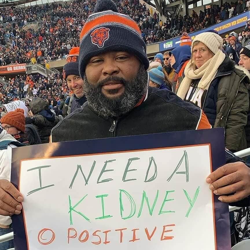 kidney transplant recipient Marcus Edwards with a sign, I Need a Kidney 0 positive